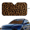 A leopard print car windshield sunshade placed on a blue car windshield.