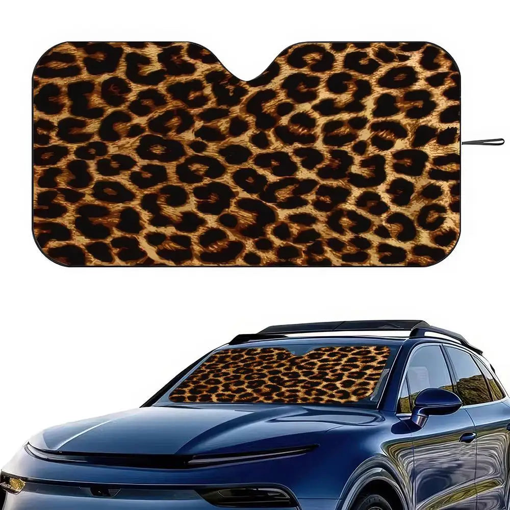 A leopard print car windshield sunshade placed on a blue car windshield.