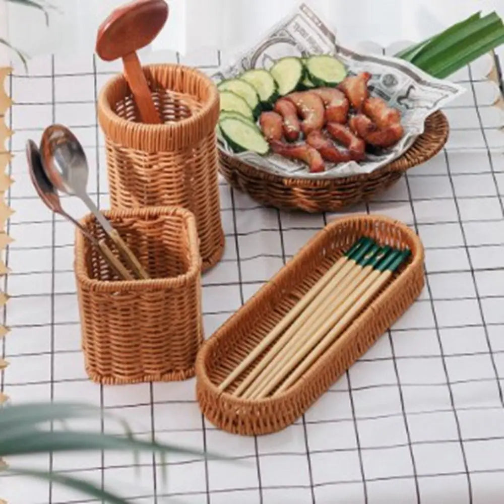 A set of seven handwoven wicker serving baskets and wooden utensils displayed on a white checkered surface.