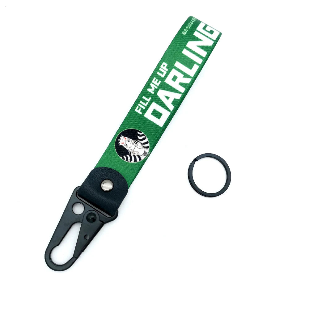 Green strap keychain with a black clip and a circular ring, featuring text that reads FILL ME UP DARLING.