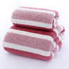 A stack of pink and white striped microfiber towels for bath and face use.