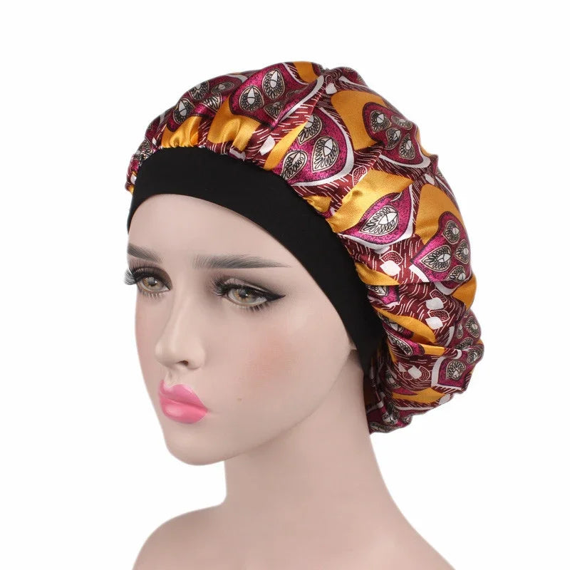 A woman wearing a satin hair bonnet with a gold and purple patterned fabric and a black elastic band.