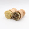 Two wooden scrub brushes with natural sisal bristles are shown against a white background.