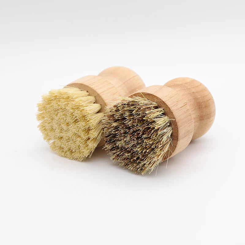 Two wooden scrub brushes with natural sisal bristles are shown against a white background.