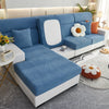 A light blue elegant jacquard sofa slipcover with white cushions and a matching white frame in a modern living room.
