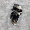 A detailed, realistic skull decal with glowing red eyes is placed on a textured gray surface.