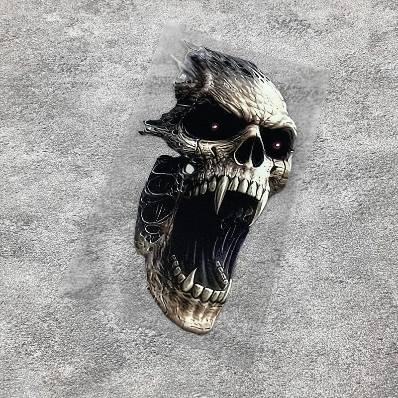 A detailed, realistic skull decal with glowing red eyes is placed on a textured gray surface.