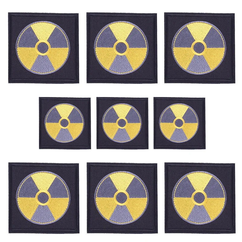 A set of ten embroidered rock skull iron-on patches featuring a radioactive symbol design on dark fabric.