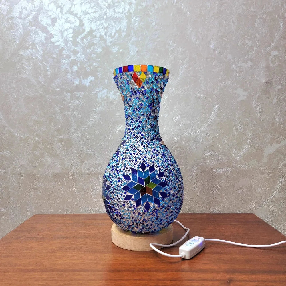 Handcrafted Turkish mosaic vase lamp with blue and multicolored glass on a wooden table.