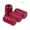A set of four knurled red aluminum tire valve caps.