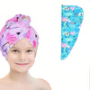 A child is wearing a purple patterned microfiber hair drying towel wrap with heart designs.