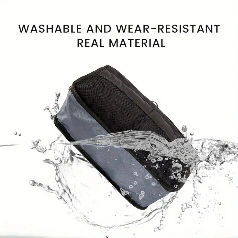 A black foldable makeup organizer bag is shown being washed in water, demonstrating its washable and wear-resistant material.