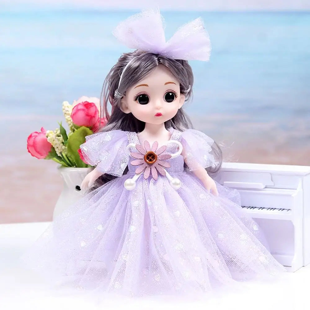 A purple princess doll with pink hair and a lavender dress is shown next to a white piano and flowers.