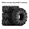 A stack of black INJORA S5 compound Swamp Claw mud terrain tires for RC crawlers.