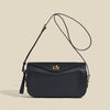 A dark navy genuine leather square crossbody bag with a gold lock and thin black strap.
