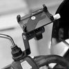 A black phone mount is attached to a bicycle handlebar, designed for mounting a phone.
