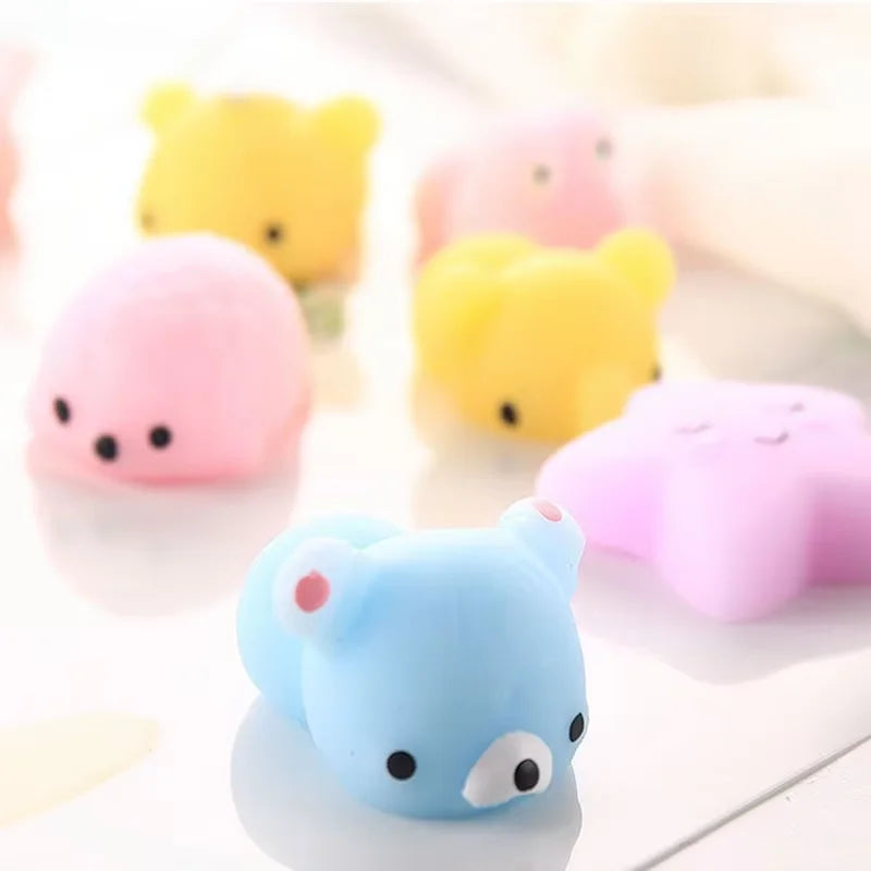 A collection of colorful animal squeeze stress relief toys including yellow, pink, and blue bears.