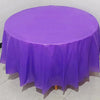 A vibrant purple disposable round tablecloth is spread on a table for parties or events.
