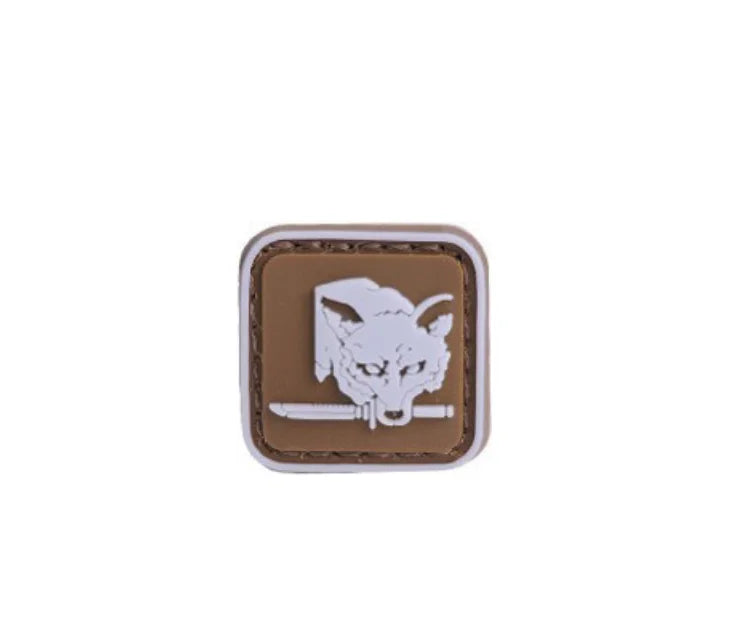 A brown embroidered patch featuring a white foxhound head with a hook and loop backing.