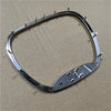 A chrome steering wheel cover for a Dodge SRT vehicle with an emblem.