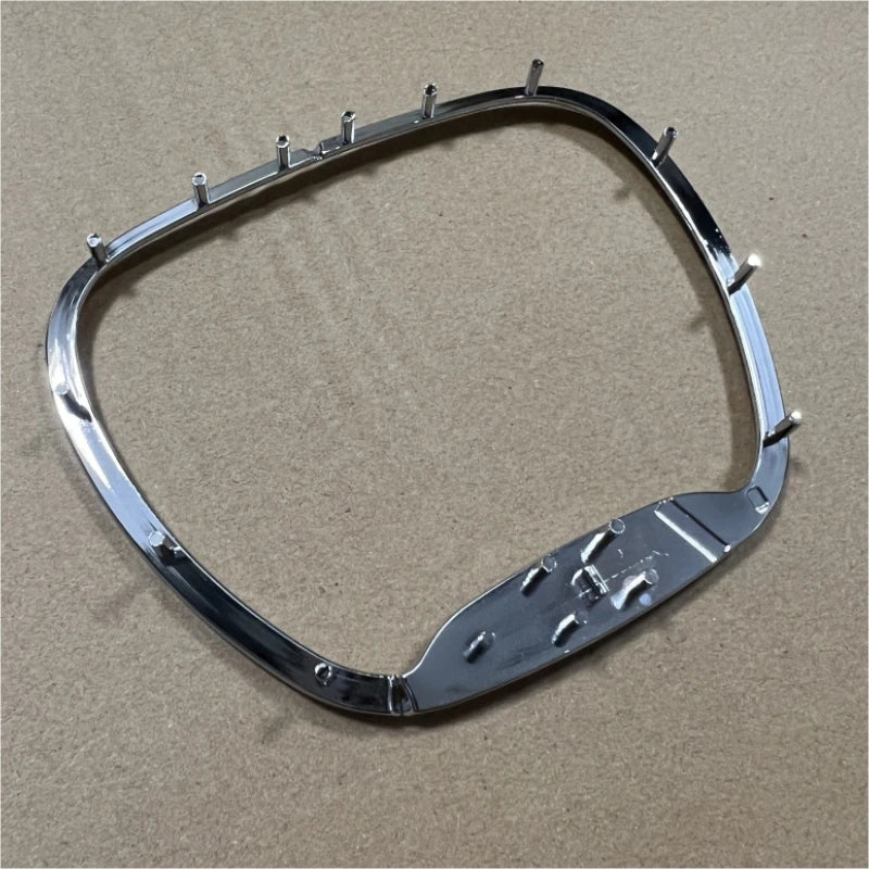 A chrome steering wheel cover for a Dodge SRT vehicle with an emblem.