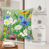 A green throw pillow cover featuring a vibrant floral pattern of white, yellow, and blue wildflowers.