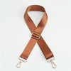 A brown nylon bag strap with a gold buckle shown in an 'X' shape.