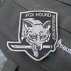 Embroidered Fox Hound patch with hook and loop backing on a gray fabric