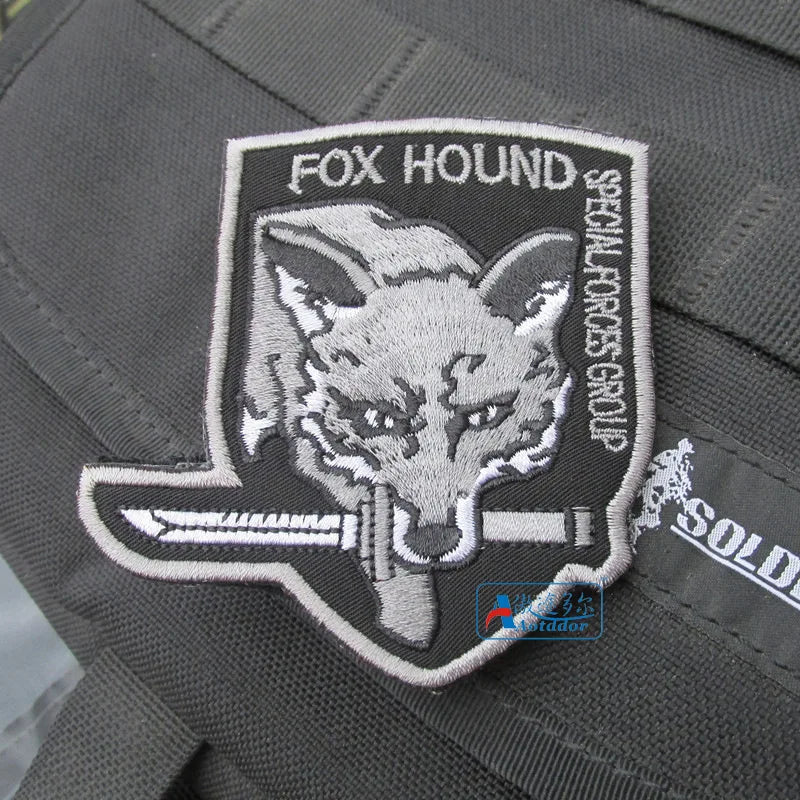 Embroidered Fox Hound patch with hook and loop backing on a gray fabric