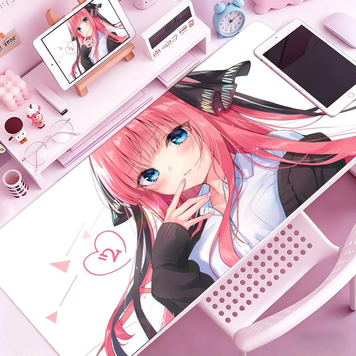Anime girl illustration on a pink mouse pad featuring pink hair and blue eyes