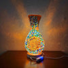 A handcrafted Turkish mosaic table lamp with a warm LED glow, featuring colorful glass pieces in a vase shape.