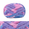 A ball of chunky chenille yarn in purple and pink stripes for hand knitting and crochet