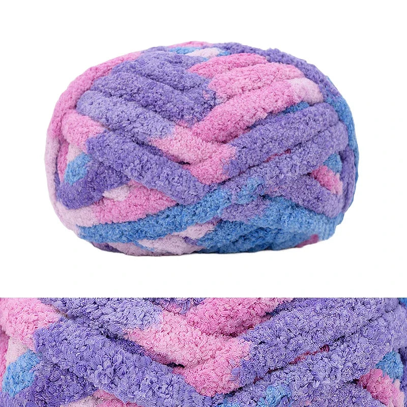 A ball of chunky chenille yarn in purple and pink stripes for hand knitting and crochet