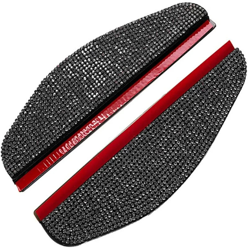 A pair of black rhinestone car rearview mirror rain guards with red trim.