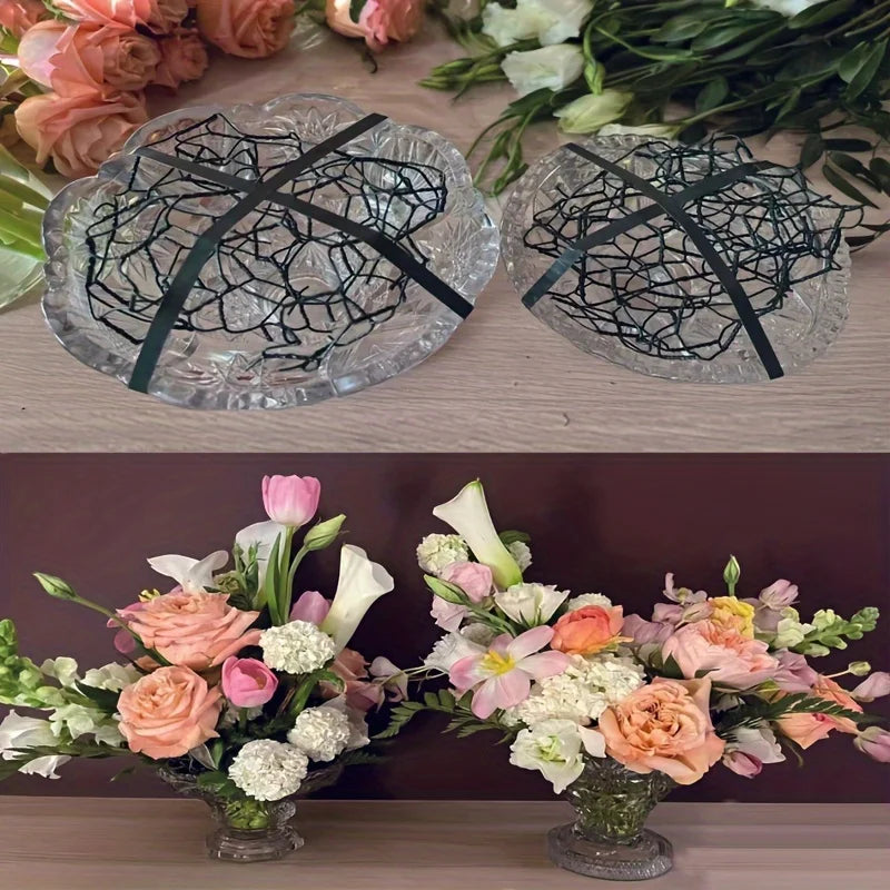 Two clear hexagonal glass panels with black netting and a floral arrangement.