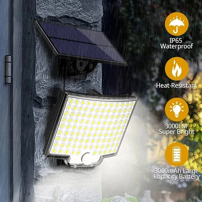 Outdoor solar flood light mounted on a wall with an attached solar panel and battery.