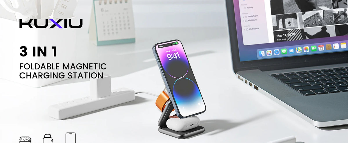 A foldable magnetic charging station is shown with an iPhone, Apple Watch, and AirPods placed on it next to a laptop.