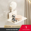 A cream white suction cup soap dish mounted on a wall, featuring a small bear design.