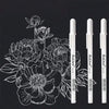 A set of white ink gel pens for drawing and highlighting shown against a black background.