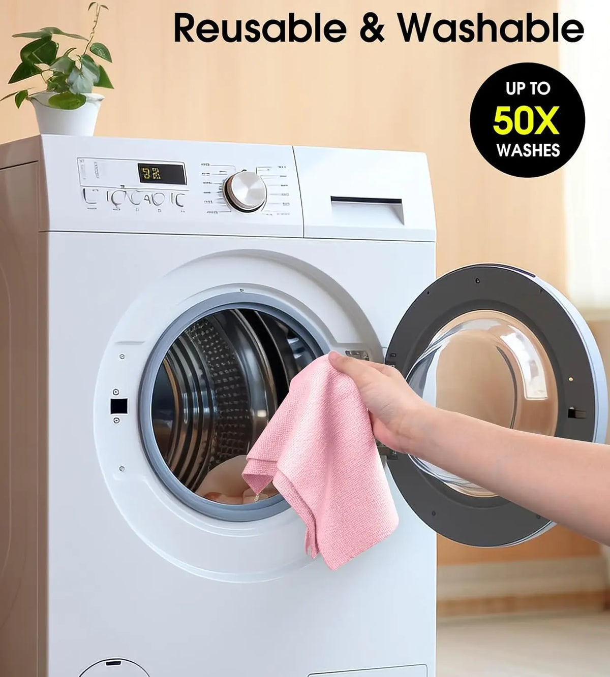 A hand places a pink reusable microfiber cleaning cloth into the drum of a white washing machine.