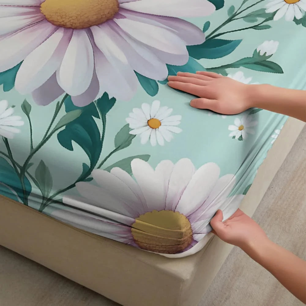 A hand is touching a fitted sheet featuring a white and purple daisy floral print on a teal background.