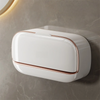 A white wall mounted waterproof soap dish with a copper trim is displayed against a gray wall.