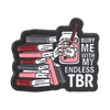Black enamel pin featuring a hand holding a glass of red liquid and several pens, with the text Bury me with my endless TBR