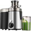 A stainless steel centrifugal juicer with a large feed tube and a glass container filled with green juice.