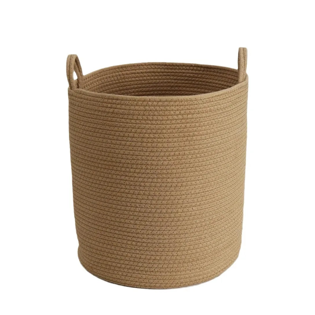 A beige handwoven cotton rope storage basket with handles.
