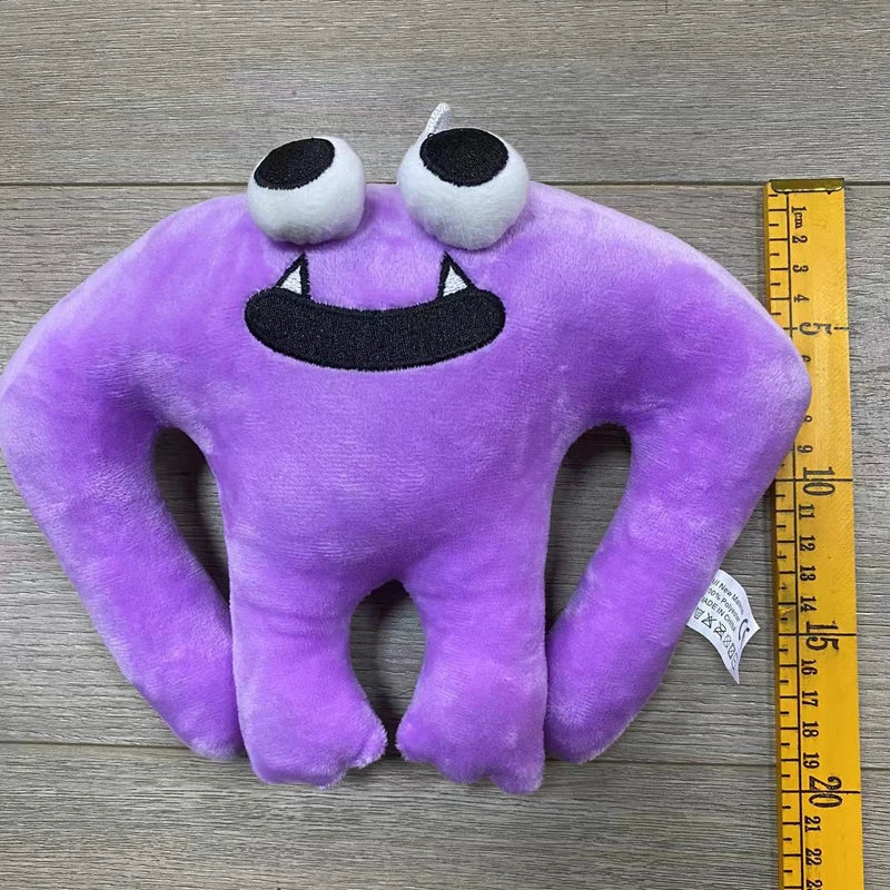 A purple plush toy of an Opila Bird with large white eyes and a black mouth on a wooden surface.