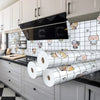 A kitchen cabinet and splashback featuring a white and black patterned tile wallpaper with animal faces.