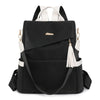 Black vegan leather backpack with white accents and a laptop compartment
