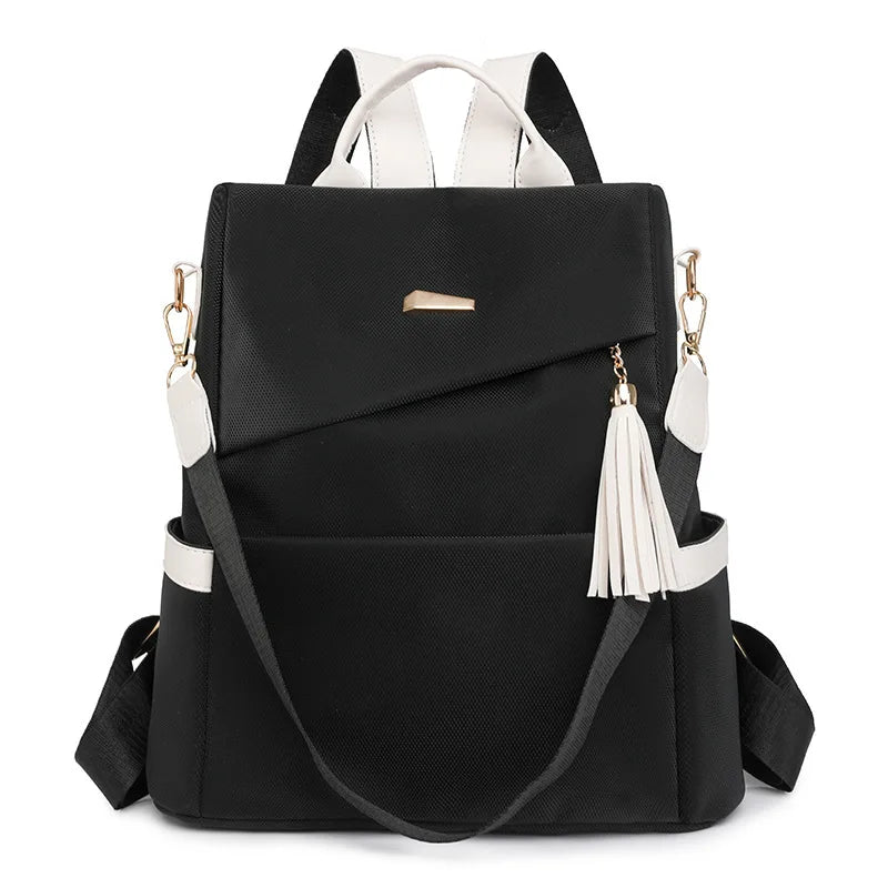 Black vegan leather backpack with white accents and a laptop compartment