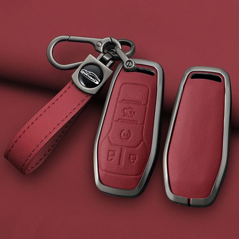 A maroon leather key case cover with a metal strap and clasp, shown against a dark red background.